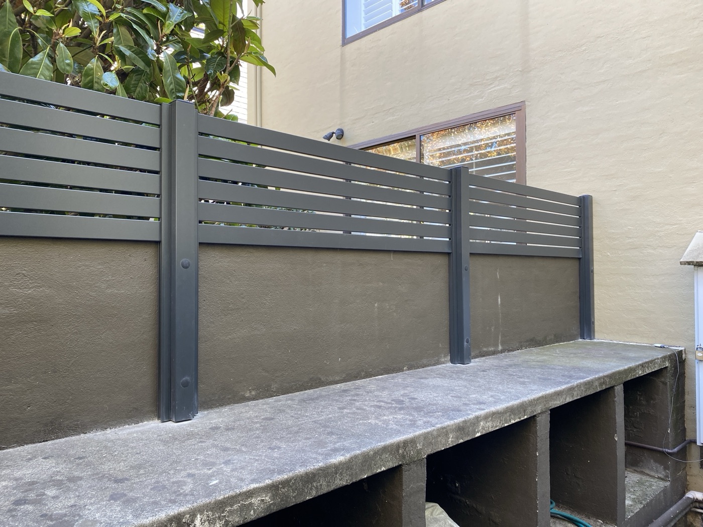 Dark slat fence panels by JT Handyman in South Yarra, VIC