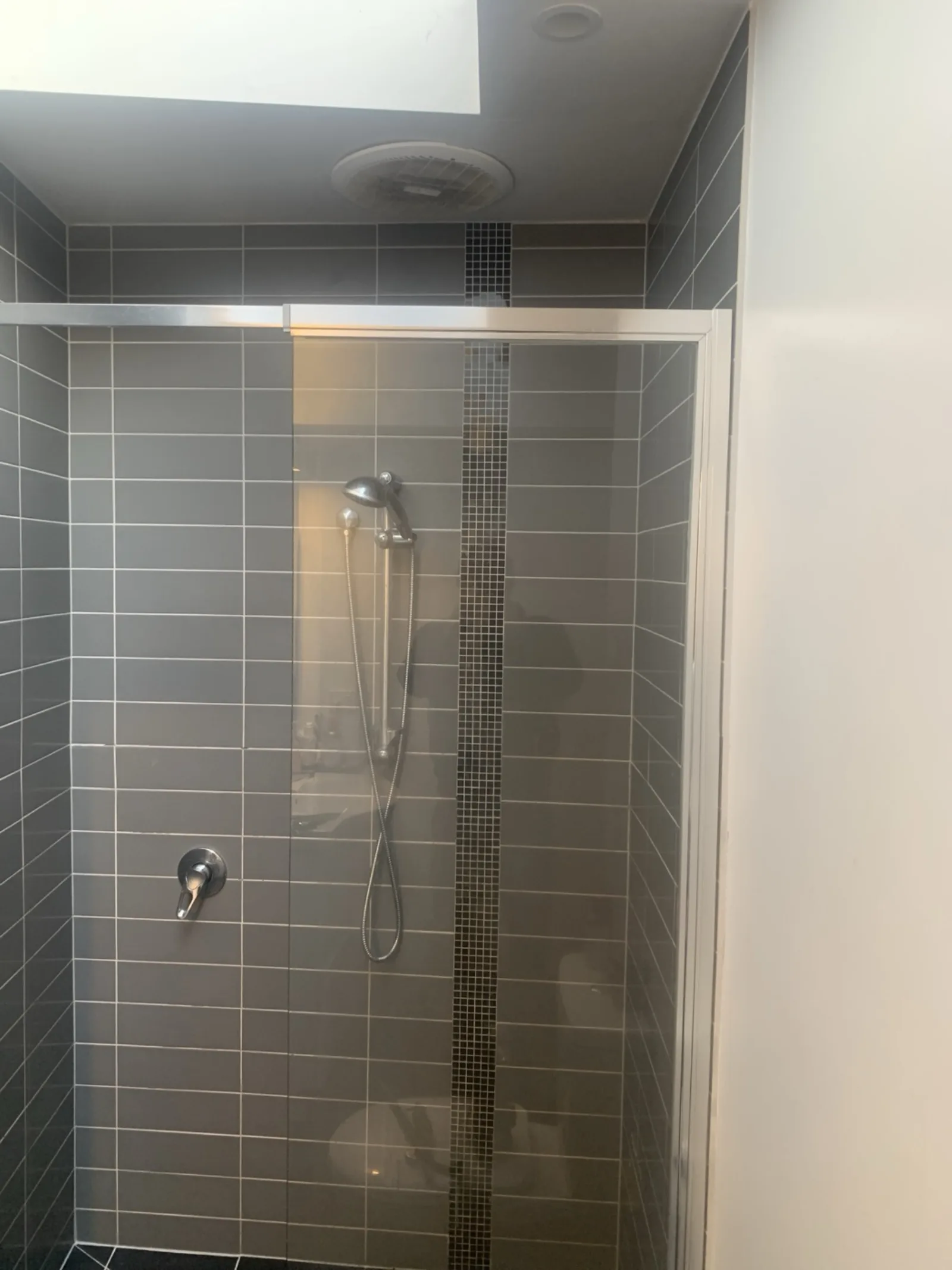 Feature-strip shower tiling by JT Handyman in North Melbourne