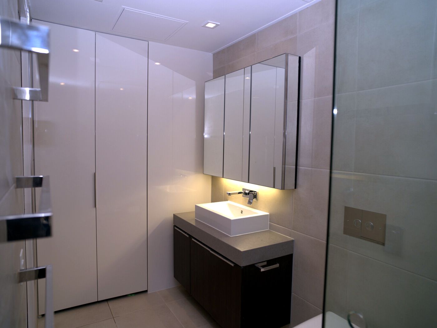 Finished bathroom with floating vanity, mirror cabinet and joinery by JT Handyman Solutionz