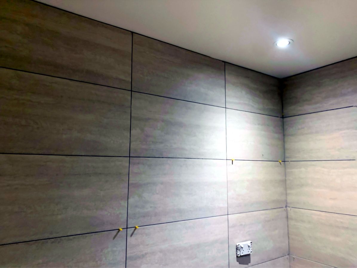 Large-format wall tiling being installed by JT Handyman Solutionz