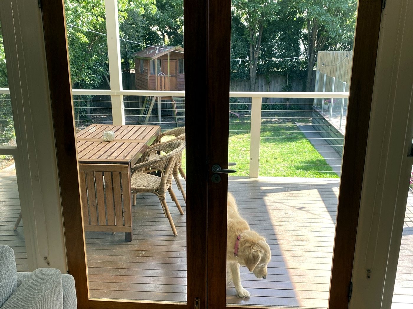 Timber French doors opening onto a deck by JT Handyman Solutionz