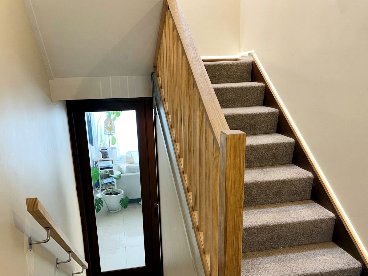 Timber balustrade and handrail on a carpeted staircase by JT Handyman Solutionz