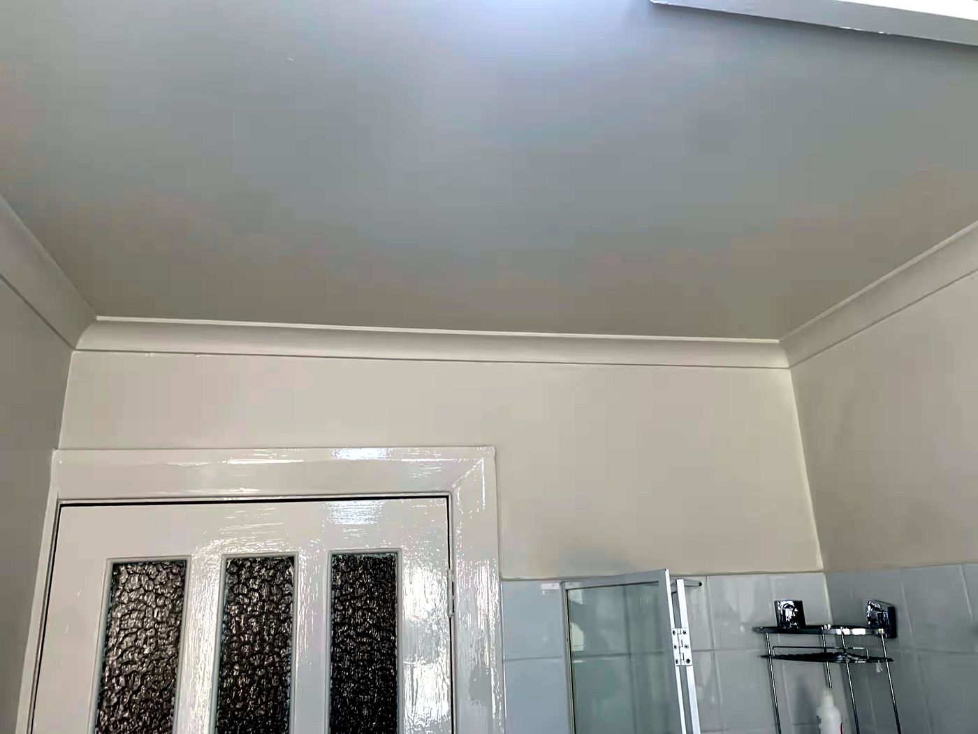 Freshly painted bathroom ceiling, cornice, walls and door trim by JT Handyman in Elwood