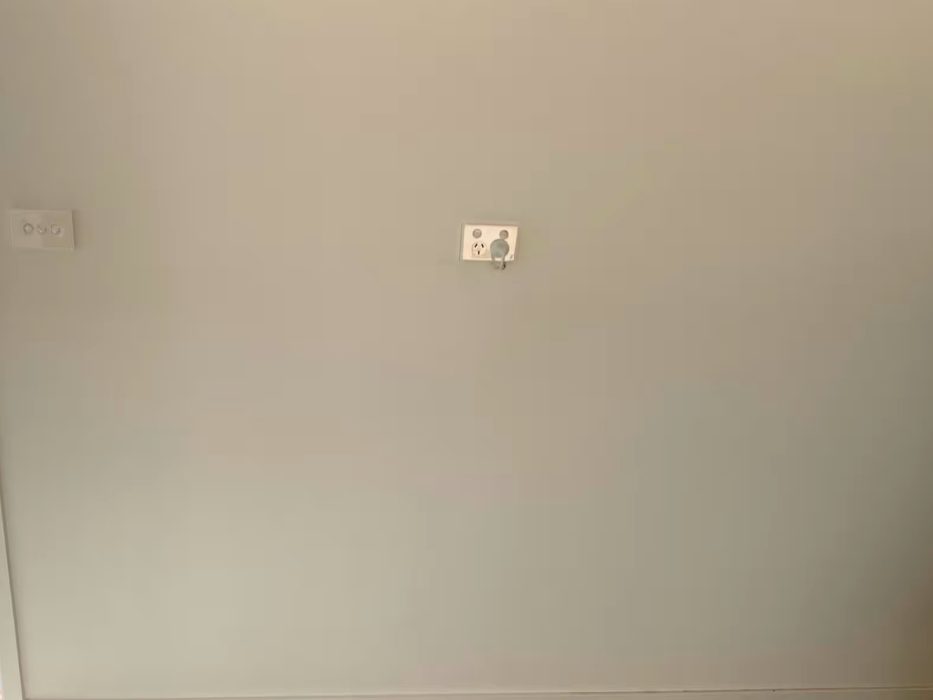 Seamless repaired wall around a switch and power point by JT Handyman Solutionz